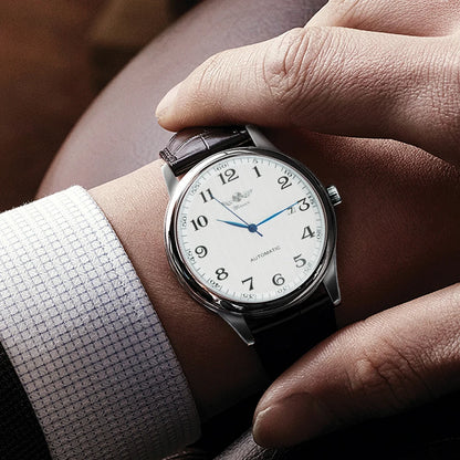 Relógio clássico para homem – Estilo retro com calendário e ponteiros azuis, movimento mecânico automático, marca de prestígio, caixa em aço e bracelete em pele